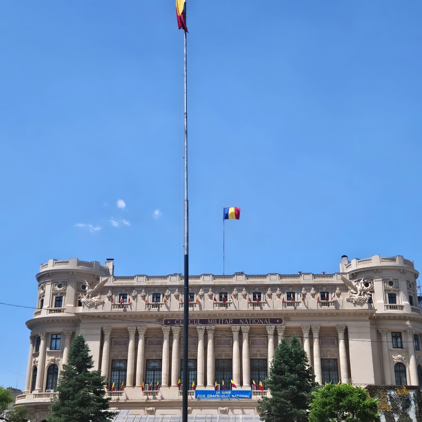 A two flag stand at the top of building